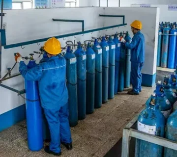 Industrial gas cylinders connected to a filling manifold at an industrial gas filling station 