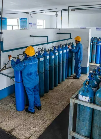 Industrial gas cylinders connected to a filling manifold at an industrial gas filling station 